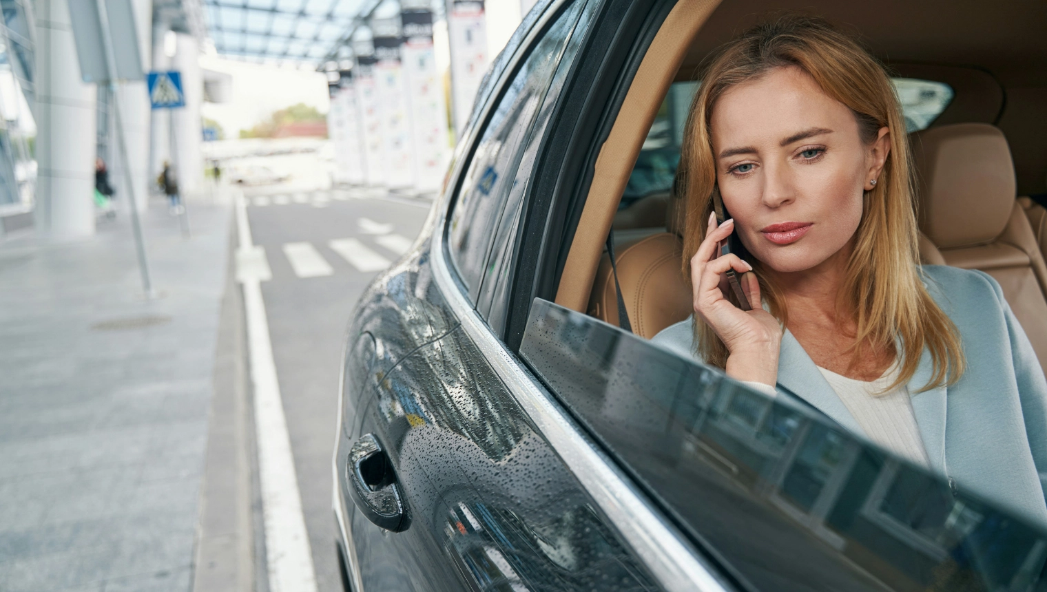 Executive professional on phone in luxury vehicle